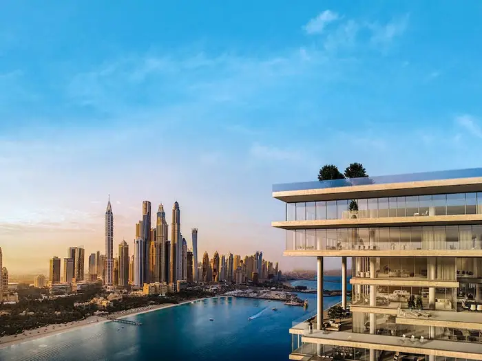 Luxury waterfront apartment with glass balconies overlooking Dubai’s skyline and marina at sunset.








